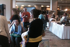 Isaac in crowd of table displays, people